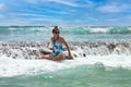 Young cute woman relaxing at tropical coral reef beach on Indian ocean. Happy female in swimsuit resting in sea water Royalty Free Stock Photo