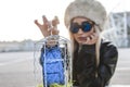 Young cute woman while showing a mobile phone inside a metal cage Royalty Free Stock Photo