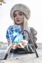 Young cute woman while showing a mobile phone inside a metal cage Royalty Free Stock Photo