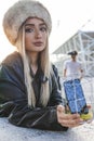 Young cute woman while showing a mobile phone inside a metal cage Royalty Free Stock Photo