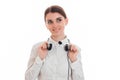 Young cutie brunette business woman with headphones and microphone smiling and looking away isolated on white background