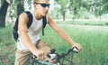 Young cyclist riding on bicycle in summer park Royalty Free Stock Photo