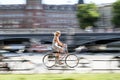 Young cyclist riding her bicycle close to the city center of Stockholm in a hot summer day. Image with intentional motion blur.