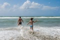 Young dad and daughter swim and play in the sea during the summer holidays