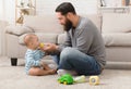 Young dad giving water to his little son Royalty Free Stock Photo