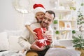 Young dad and his son celebrate christmas together