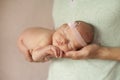 A newborn baby sleeps in the arms of his dad Royalty Free Stock Photo