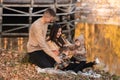 Young dad and mom with baby girl and little son having fun on blanket near pond in autumn park on sunny day. happy family concept Royalty Free Stock Photo