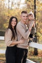 Young dad and mom with baby girl walking in autumn park on sunny day. happy family concept. mother`s, father`s, baby`s day Royalty Free Stock Photo