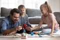 Young dad playing with kids building with bricks Royalty Free Stock Photo