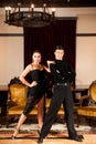 Young dance couple preforming latin show dance in ancient ballroom Royalty Free Stock Photo