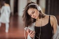 Young dancer with headphones on training in studio Royalty Free Stock Photo