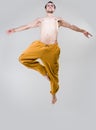 Young dancer jumping over gray background Royalty Free Stock Photo