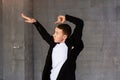 Young dancer posing on grey background. Royalty Free Stock Photo