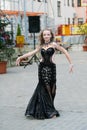Young dancer in traditional dress, young woman dancing arabic dance, street group. The girl is dancing in public. The girl in