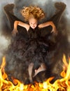 Young dark angel rising from the flames