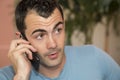Young dark haired male model talking on his cell phone Royalty Free Stock Photo