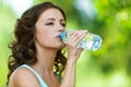 Young dark-haired woman drinking