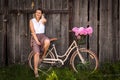 Woman with bouquet of peonies and bicycle Royalty Free Stock Photo