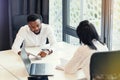 Likable purposeful business partners carefully studying financial documents with charts at the boardroom table at the