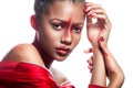 Young dark-skinned girl with abstract asymmetric red make-up Royalty Free Stock Photo