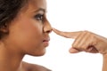 Woman touching her nose Royalty Free Stock Photo