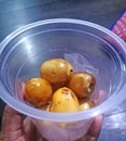 young dates in a plastic cup