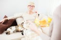 Mature woman lying in bed with pet cat and waiting for breakfast Royalty Free Stock Photo