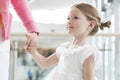 Young daughter holding mothers hand