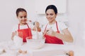 Young Daughter Preparation Dough. Fun Kid and Mom.