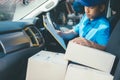 Young Delivery Man Checking Customer List On Clipboard. Royalty Free Stock Photo