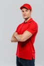 Young delivery man smiling while posing with arms crossed Royalty Free Stock Photo