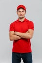 Young delivery man smiling while posing with arms crossed Royalty Free Stock Photo