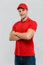 Young delivery man smiling while posing with arms crossed Royalty Free Stock Photo