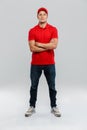 Young delivery man wearing uniform posing with arms crossed Royalty Free Stock Photo