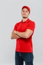 Young delivery man wearing uniform posing with arms crossed Royalty Free Stock Photo