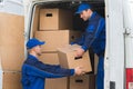 Delivery Men Unloading Boxes From Truck Royalty Free Stock Photo