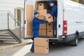 Delivery Men Unloading Boxes From Truck Royalty Free Stock Photo