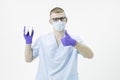 Young dentist doctor holds model of molar tooth looking at camera gesture okay