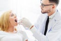 Young dentist examining patient in dental clinic. Royalty Free Stock Photo