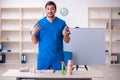 Young male dentist lecturer in front of whiteboard Royalty Free Stock Photo