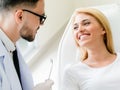 Young dentist talks with patient in dental clinic. Royalty Free Stock Photo