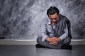 Depressed businessman sitting on the floor Royalty Free Stock Photo