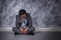 Depressed businessman sitting on the floor Royalty Free Stock Photo