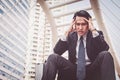 Young depressed businessman sitting on the stairs Royalty Free Stock Photo