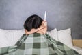 Young depressed and desperate woman or teenager crying and scared testing positive result on pregnancy test alone in bed feeling r Royalty Free Stock Photo