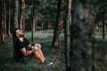 Young depressed man sitting alone in the woods Royalty Free Stock Photo