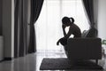 Young depressed woman domestic and rape violence beaten and raped sitting in the corner International Day for the Elimination Royalty Free Stock Photo