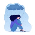 Young depressed woman sitting under metaphoric rainy cloud. Lonely sad female hugging her knees. Concept of depression Royalty Free Stock Photo