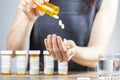 a young depressed woman is taking pills out of the medication bottle Royalty Free Stock Photo